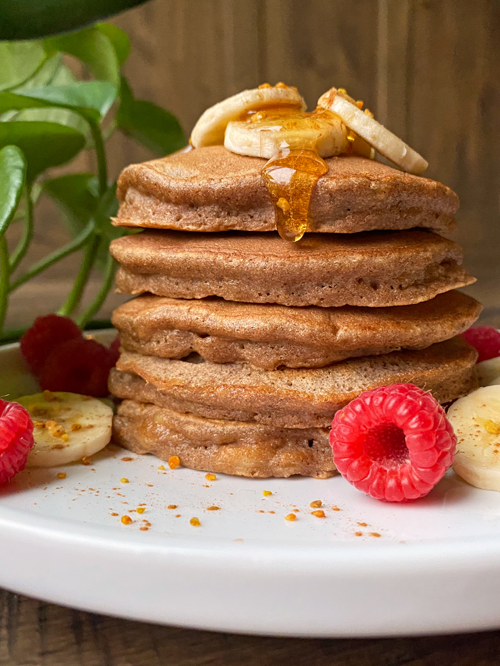 Banana pancakes topped with sliced bananas, honey and bee pollen.