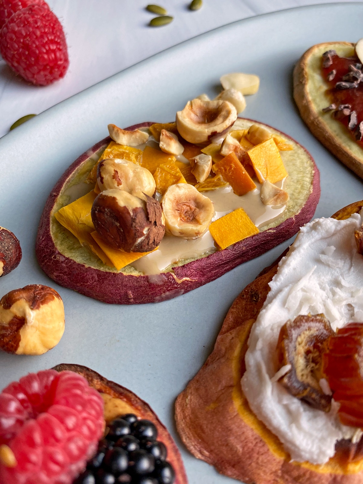 Paleo-toast-with-tahini-mango-and-hazelnuts