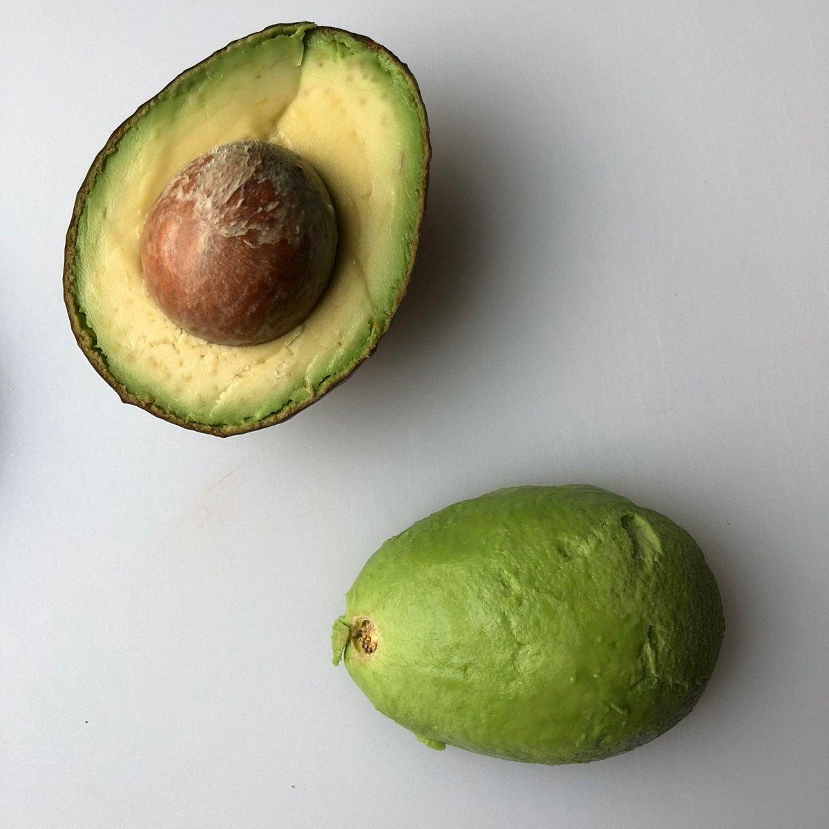 step three - peel one half of avocado and set face down on cutting board