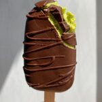 holding a mint chip ice cream bar