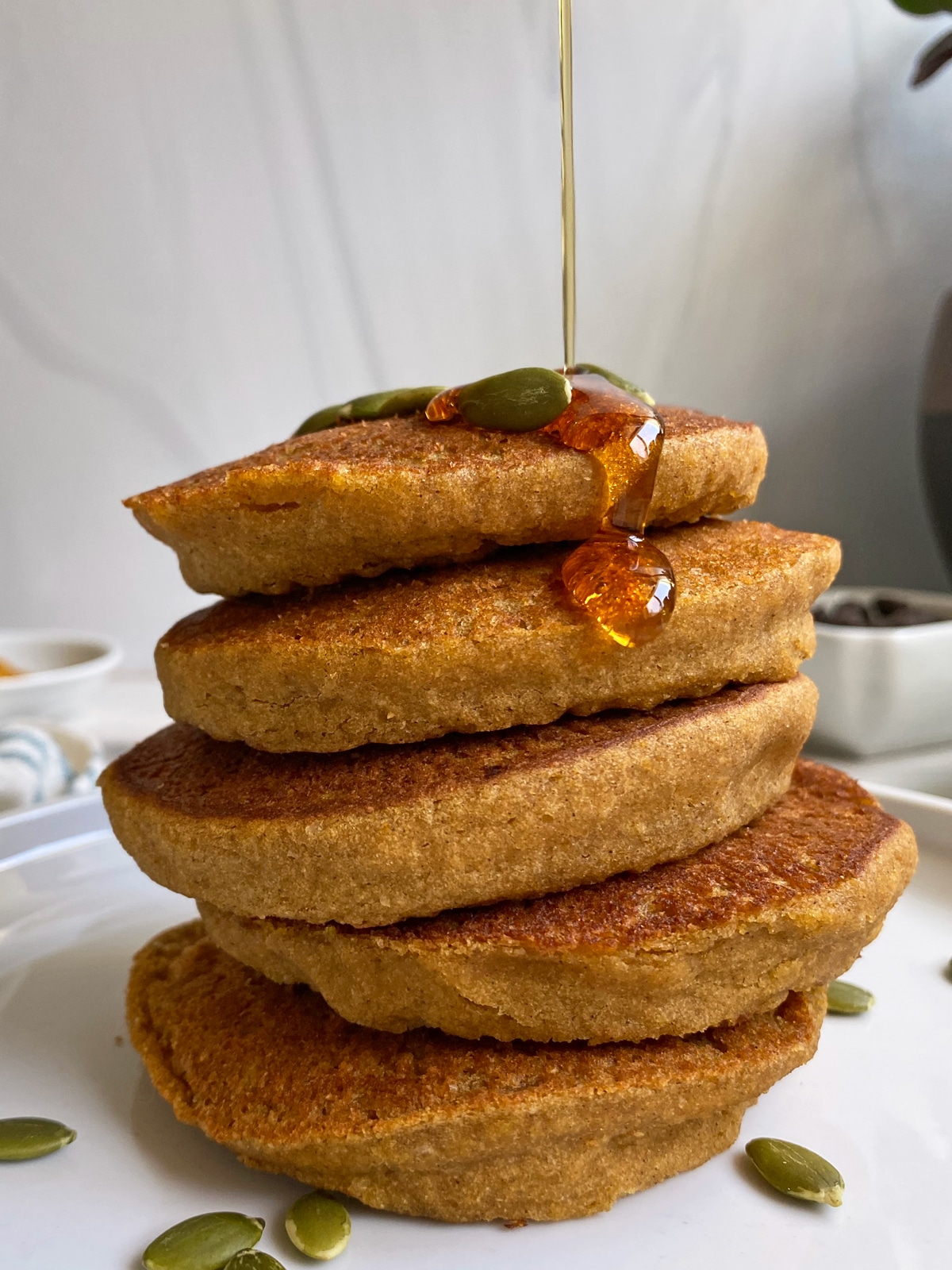 stack of pancakes drizzled with maple syrup