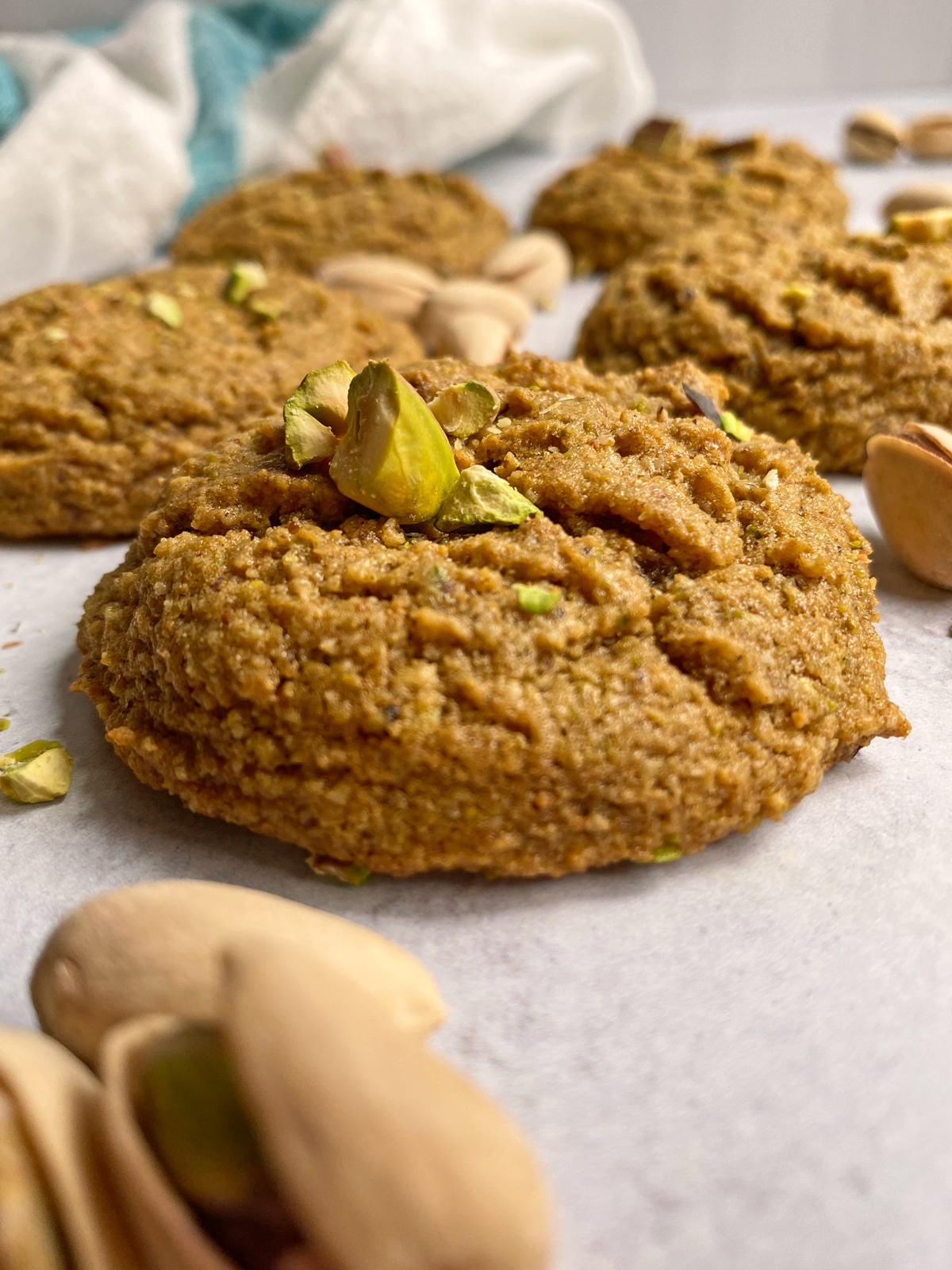 side view of pistachio cookie with crushed pistachios on top