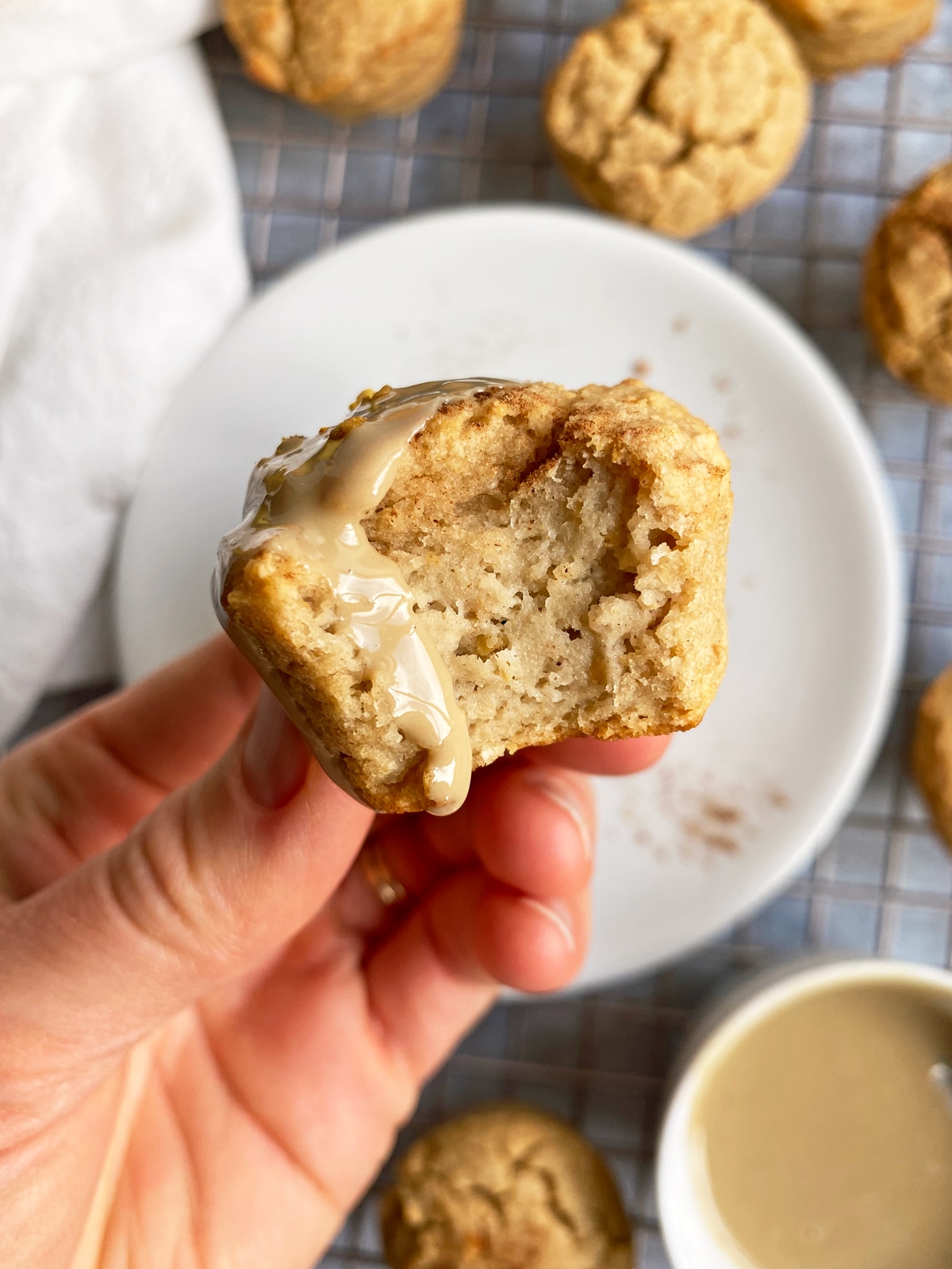 holding a pear muffin topped with tahini