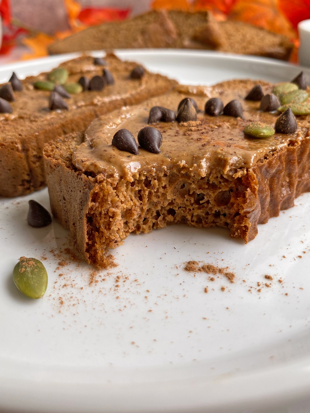 collagen bread topped with almond butter, dark chocolate chips, pumpkin seeds and cinnamon