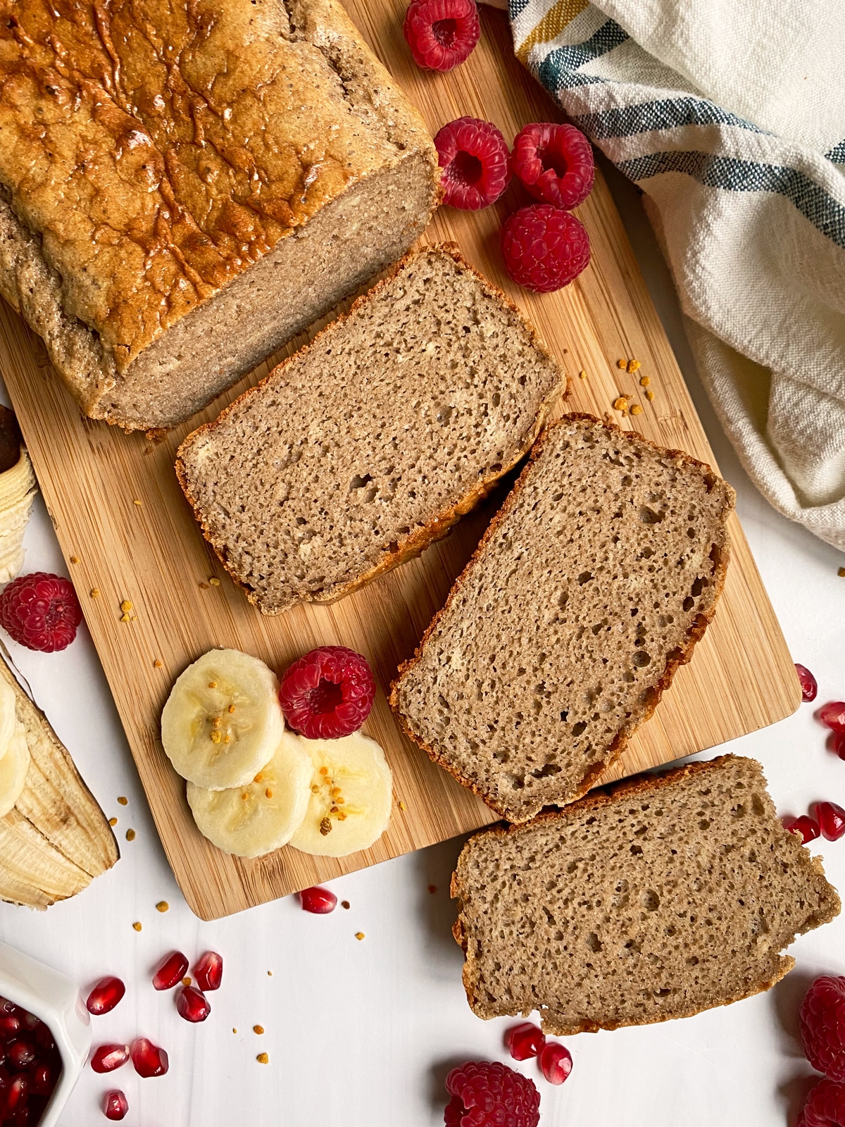 loaf of collagen banana bread on a wooden cutting board