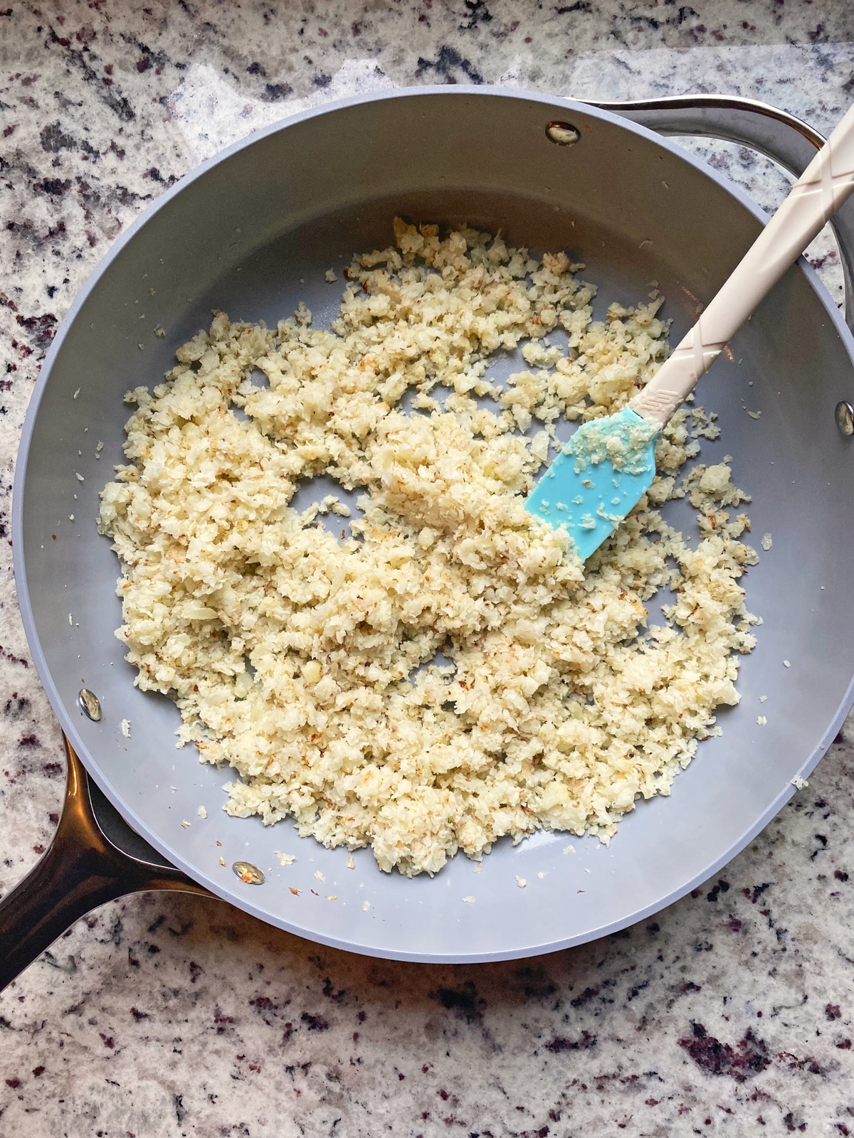 cooked cauliflower rice on frying pan