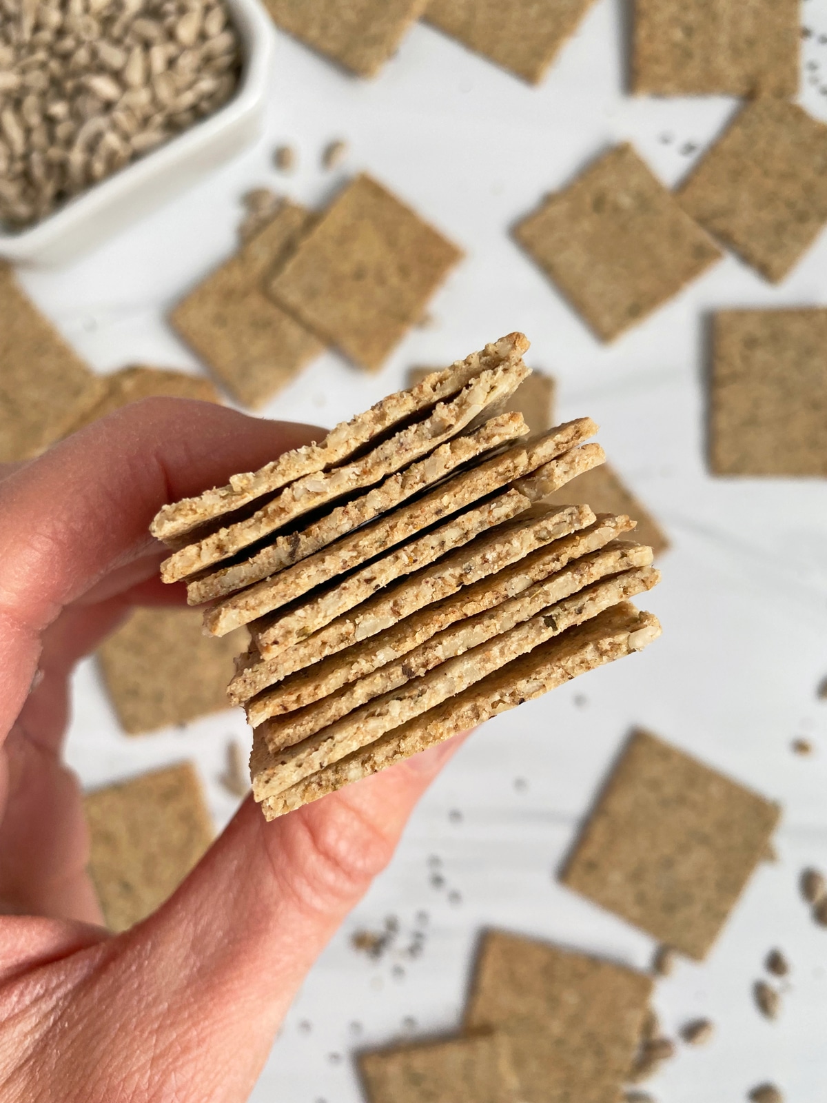 holding a stack of crackers