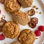 muffins on plate decorated with dates and raspberries