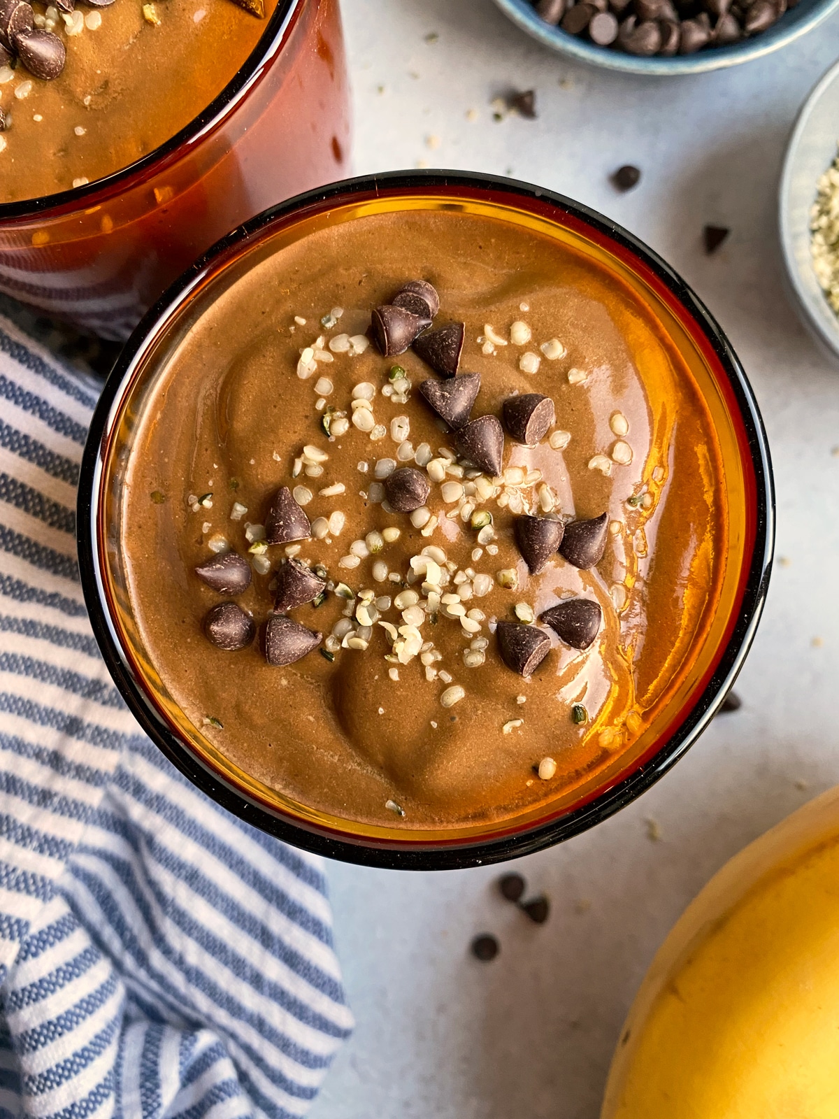 Top view of chocolate avocado smoothie with hemp seeds and mini chocolate chips.