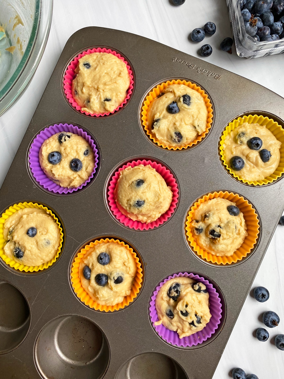 blueberry-muffin-batter-in-lined-muffin-pan