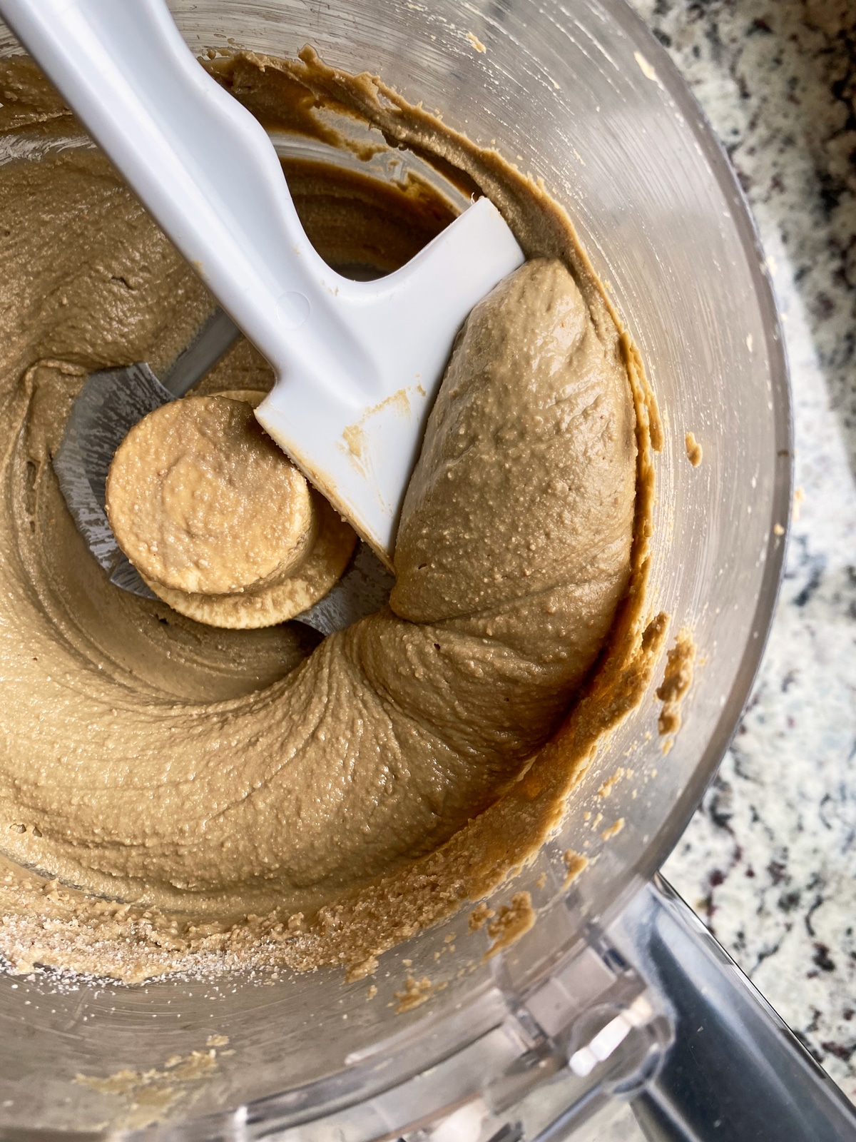 scooping the sunflower seed butter out with a spatula