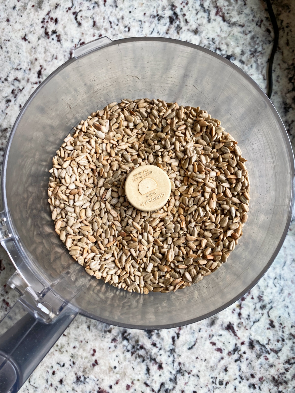 sunflower seed in food processor, ready to be blended