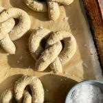 vegan soft baked pretzels on lined baking sheet