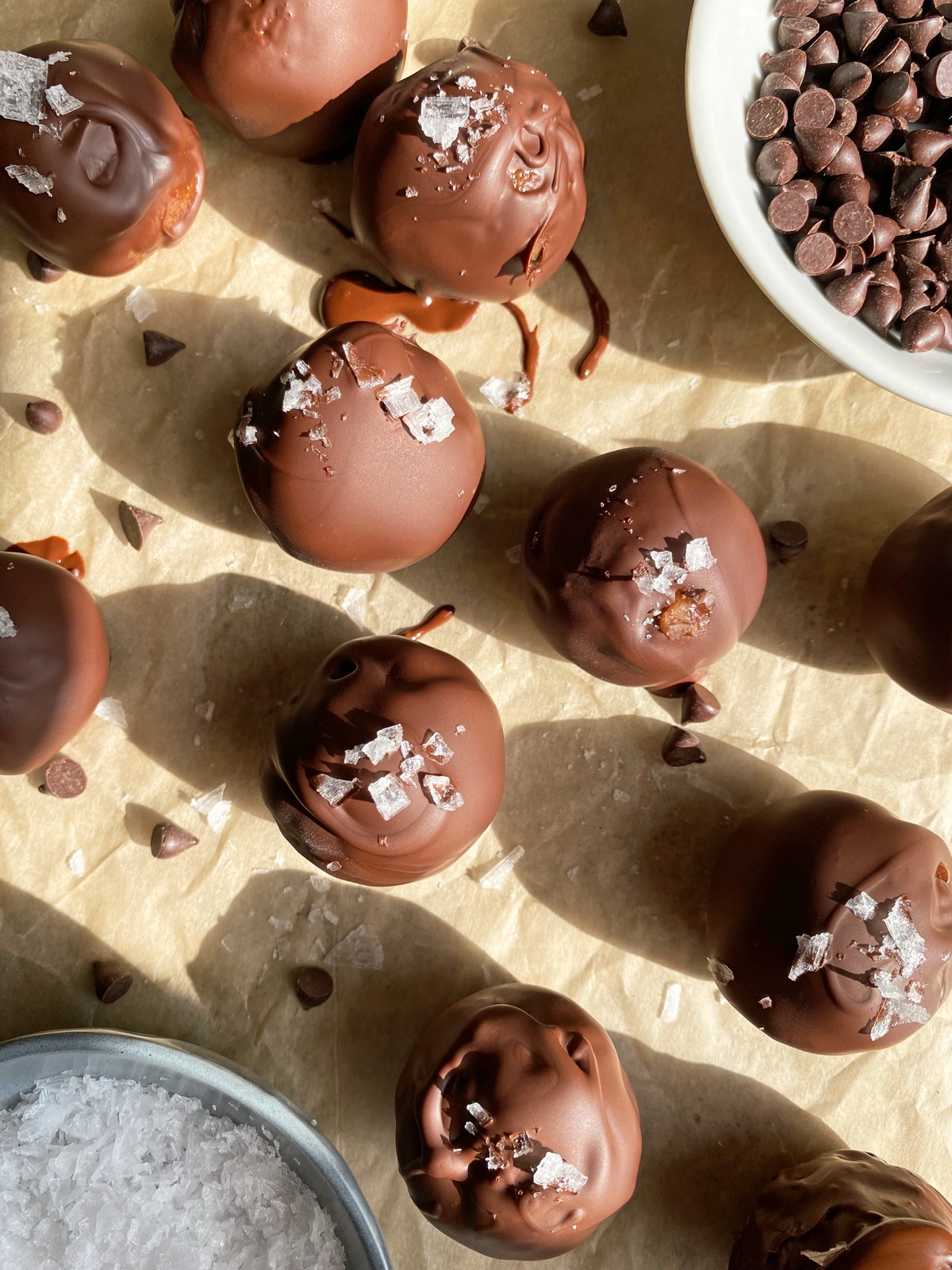 cookie dough protein balls topped with chocolate and flaked salt