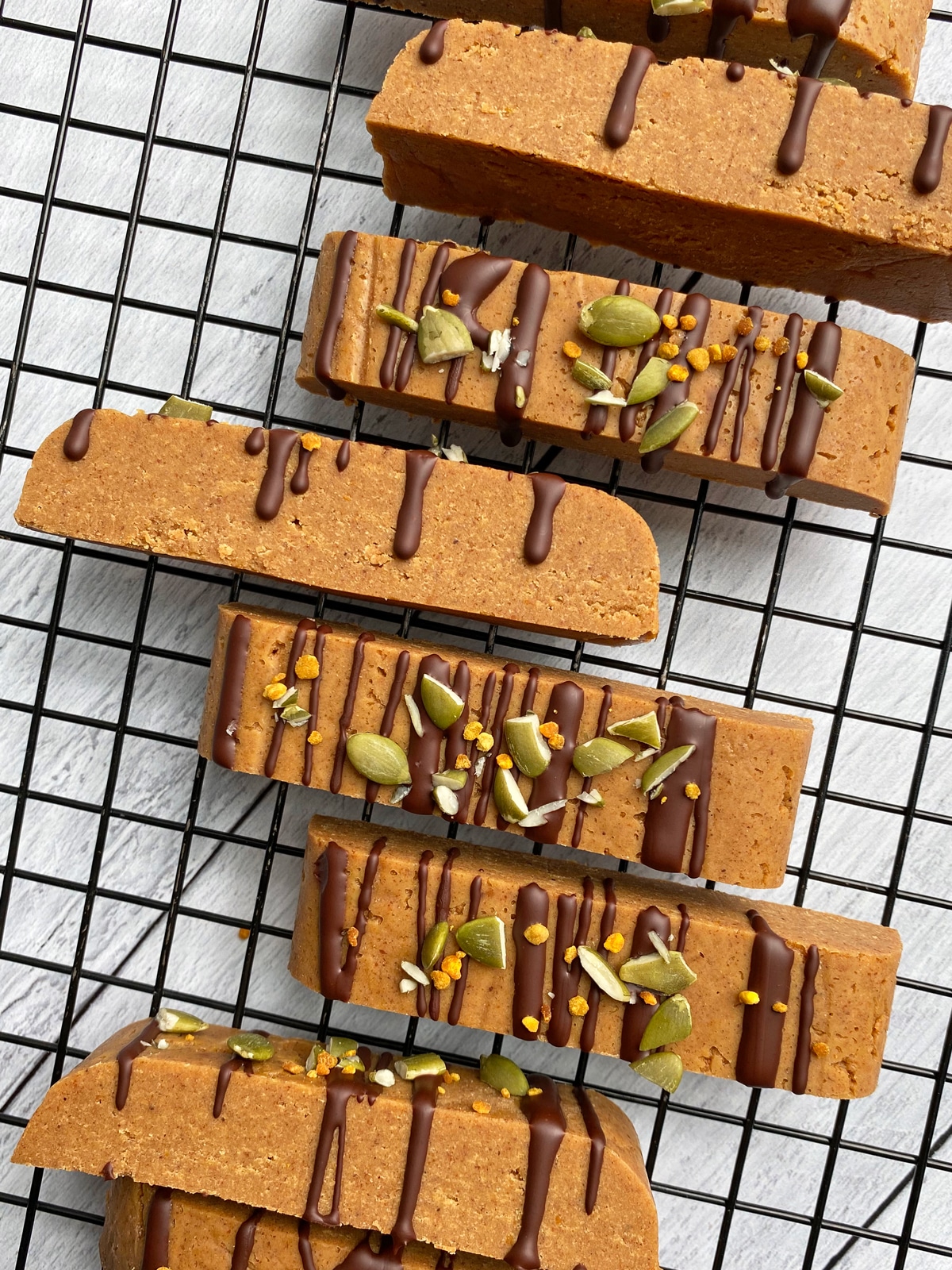 protein bars on wire cooling rack, drizzled with chocolate