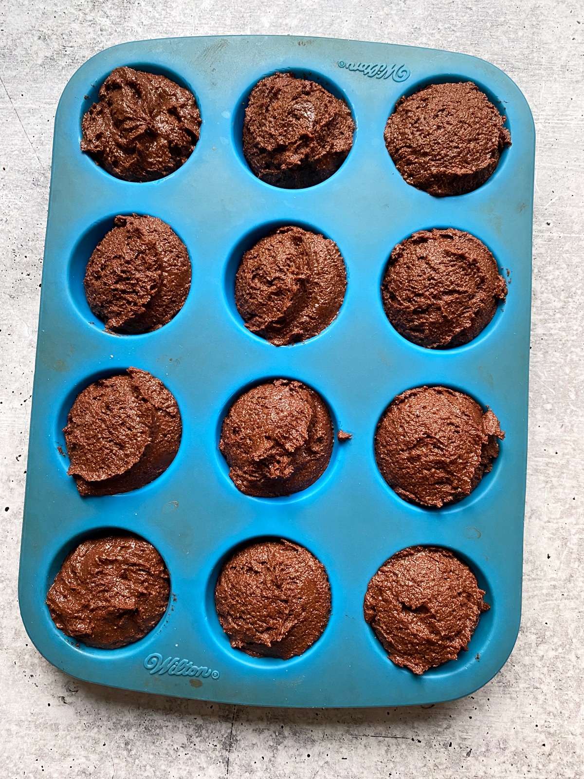 unbaked muffins in silicone baking pan