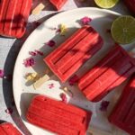homemade strawberry popsicles laid out on a plate