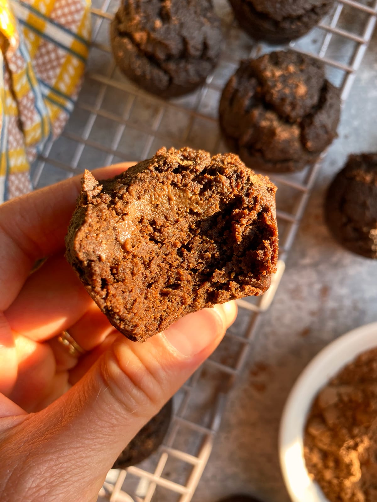 holding a muffin and showing the inside texture