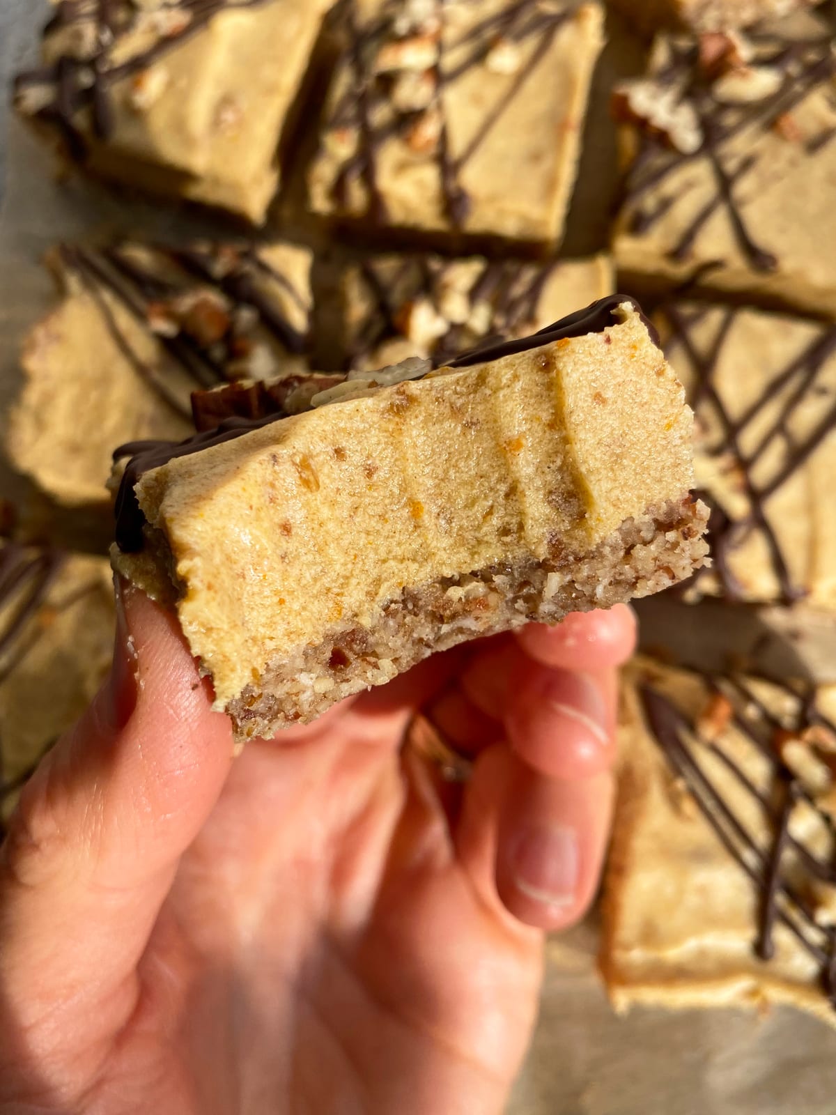 holding a pumpkin bar with a bite out of it