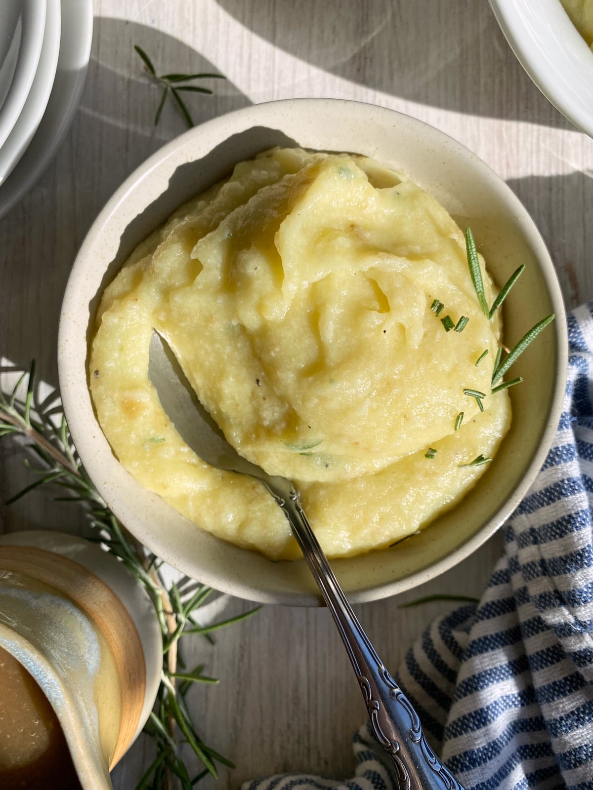 bowl of paleo cauliflower mashed potatoes with a spoon in it