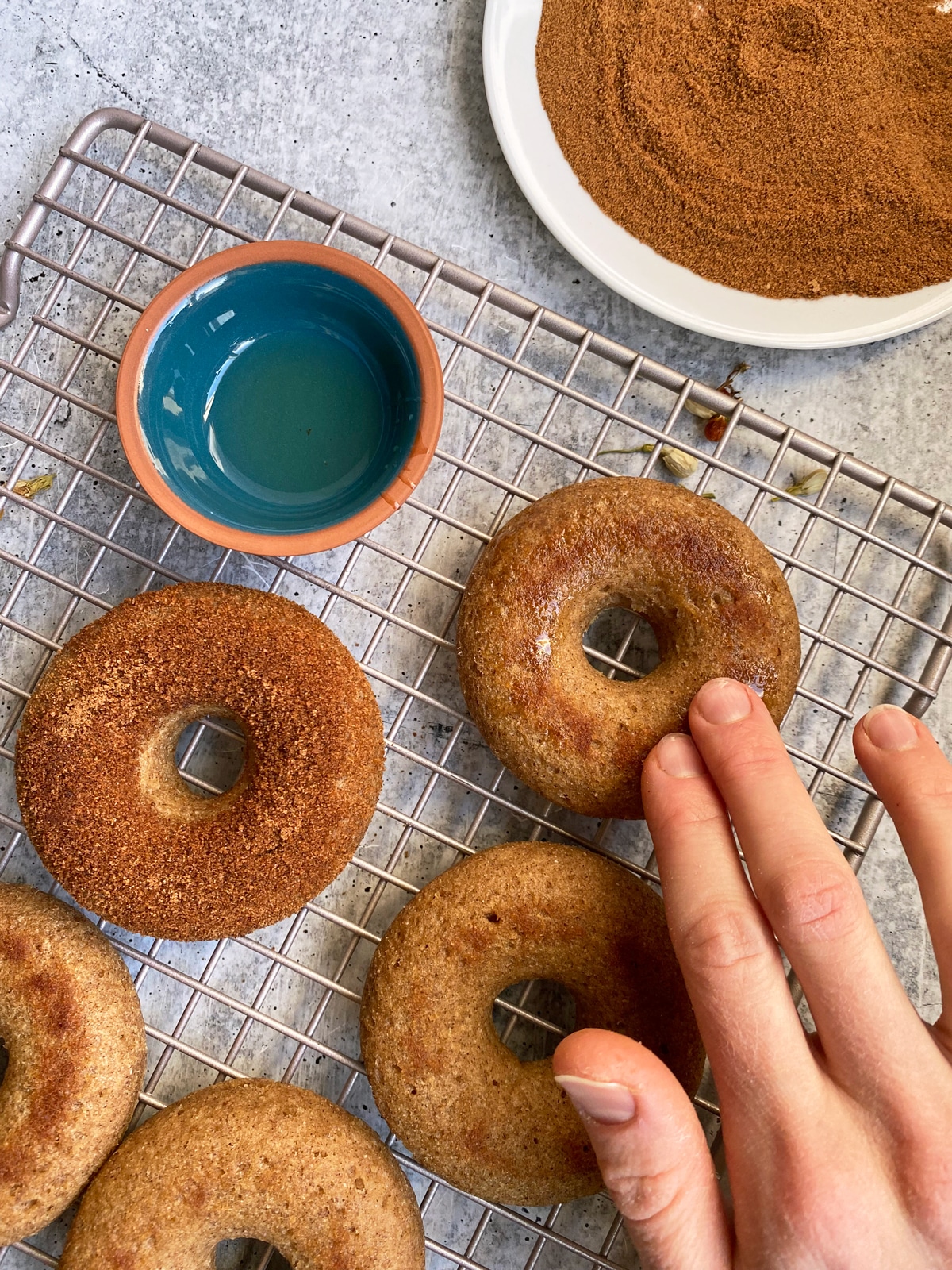 coating the donuts in avocado oil so that the cinnamon sugar mixture will stick
