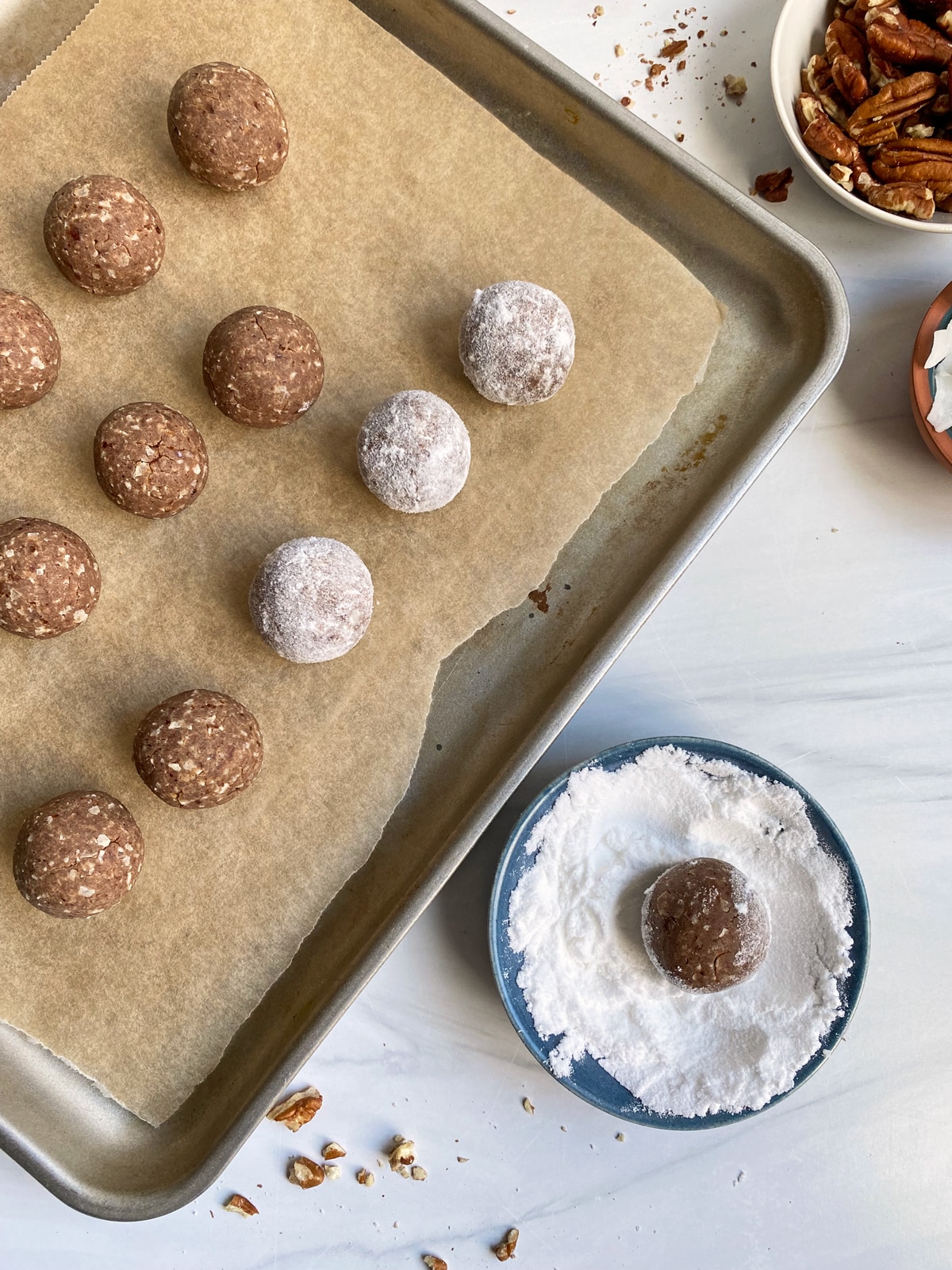 rolling-baked-donut-holes-in-powdered-sugar