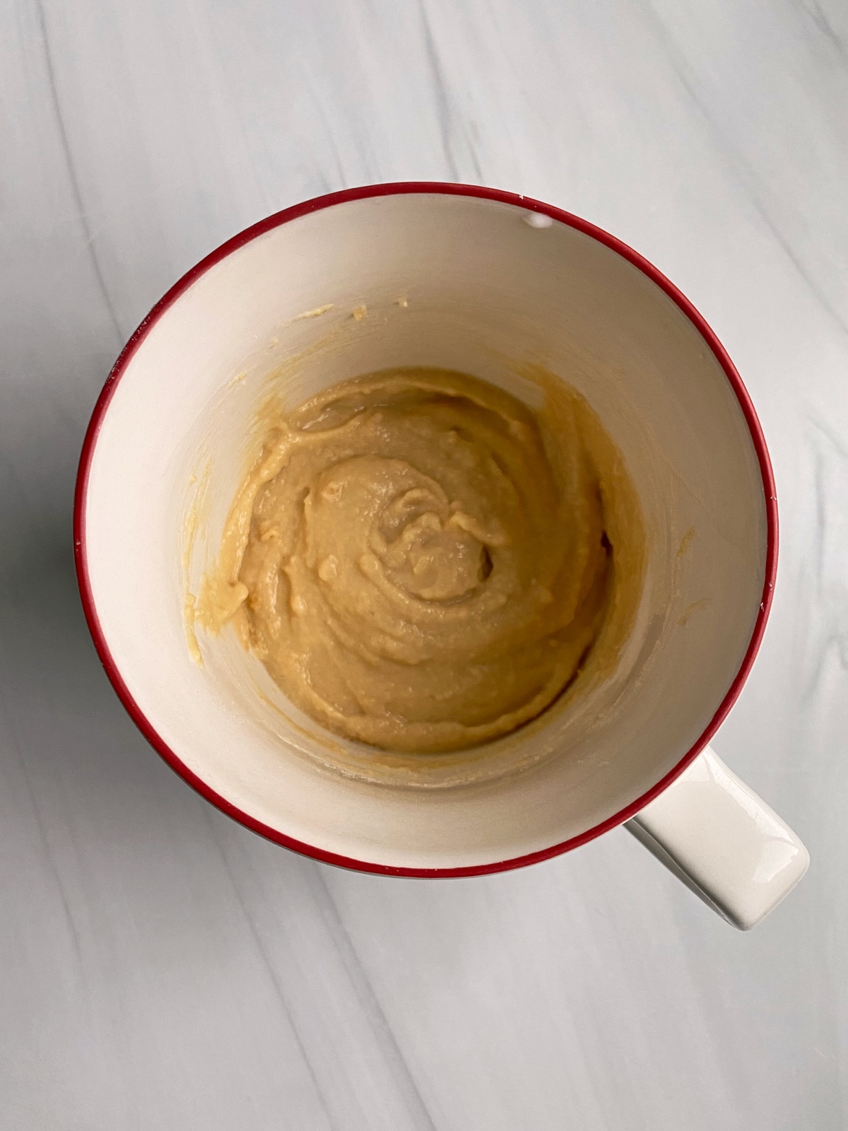 unbaked mug cake in large cup