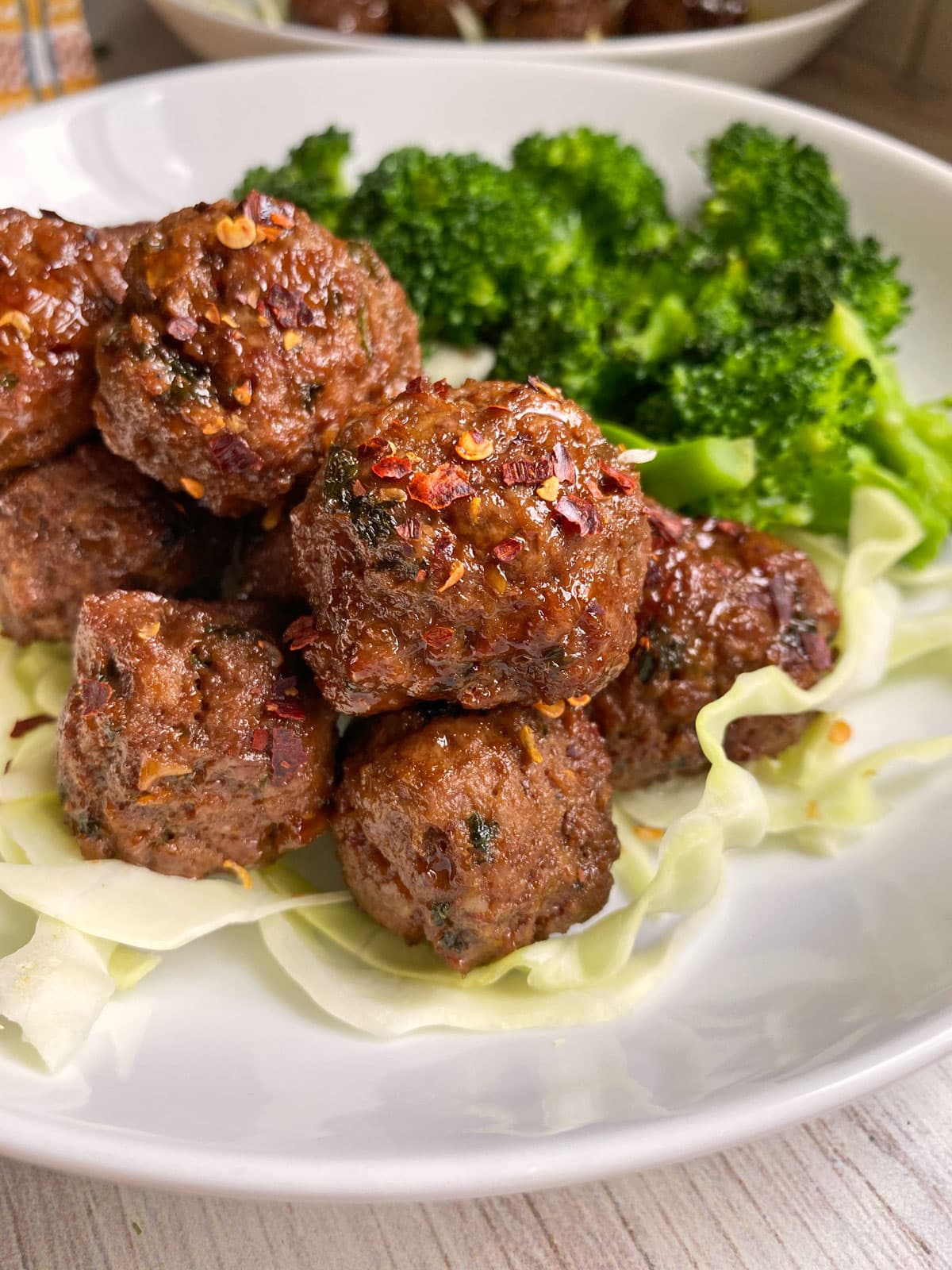 side view of meatballs on plate with veggies