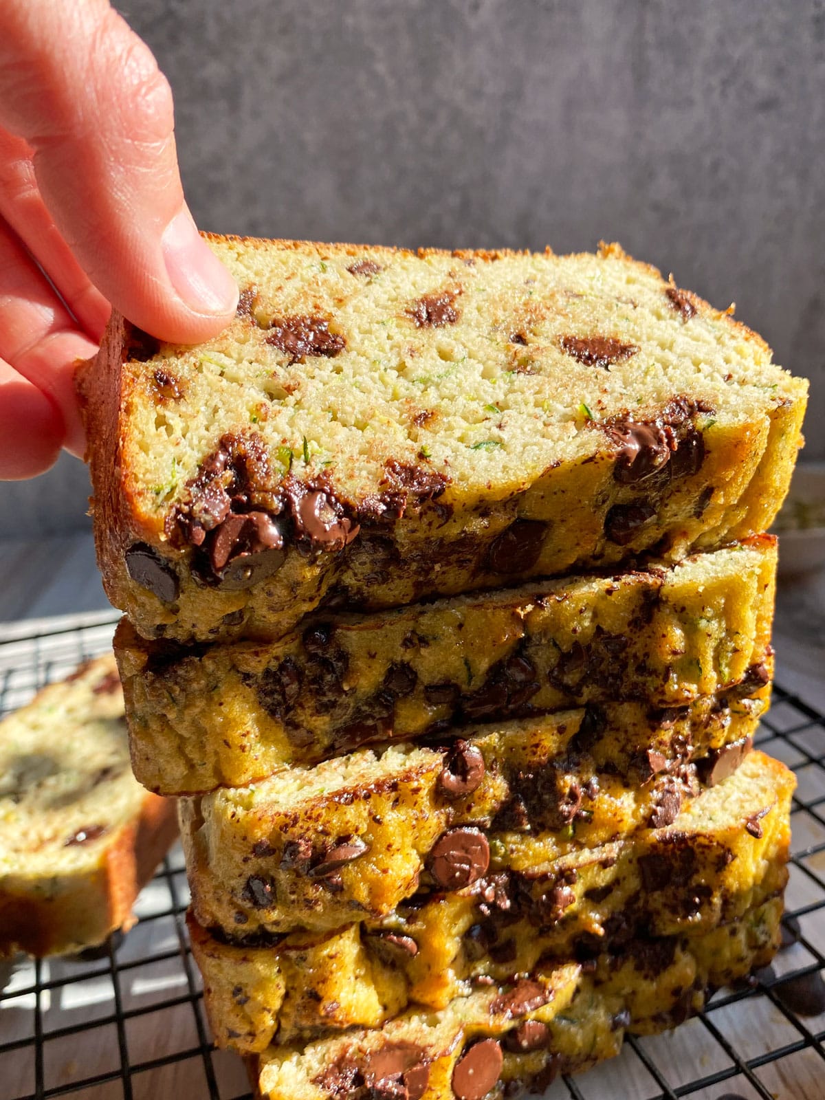 grabbing a slice of chocolate chip zucchini bread