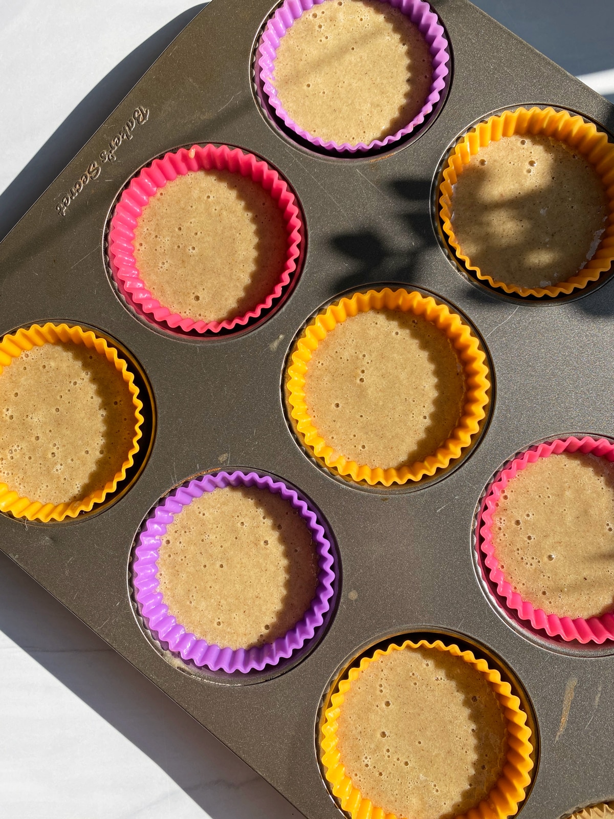 muffin batter in lined muffin pan