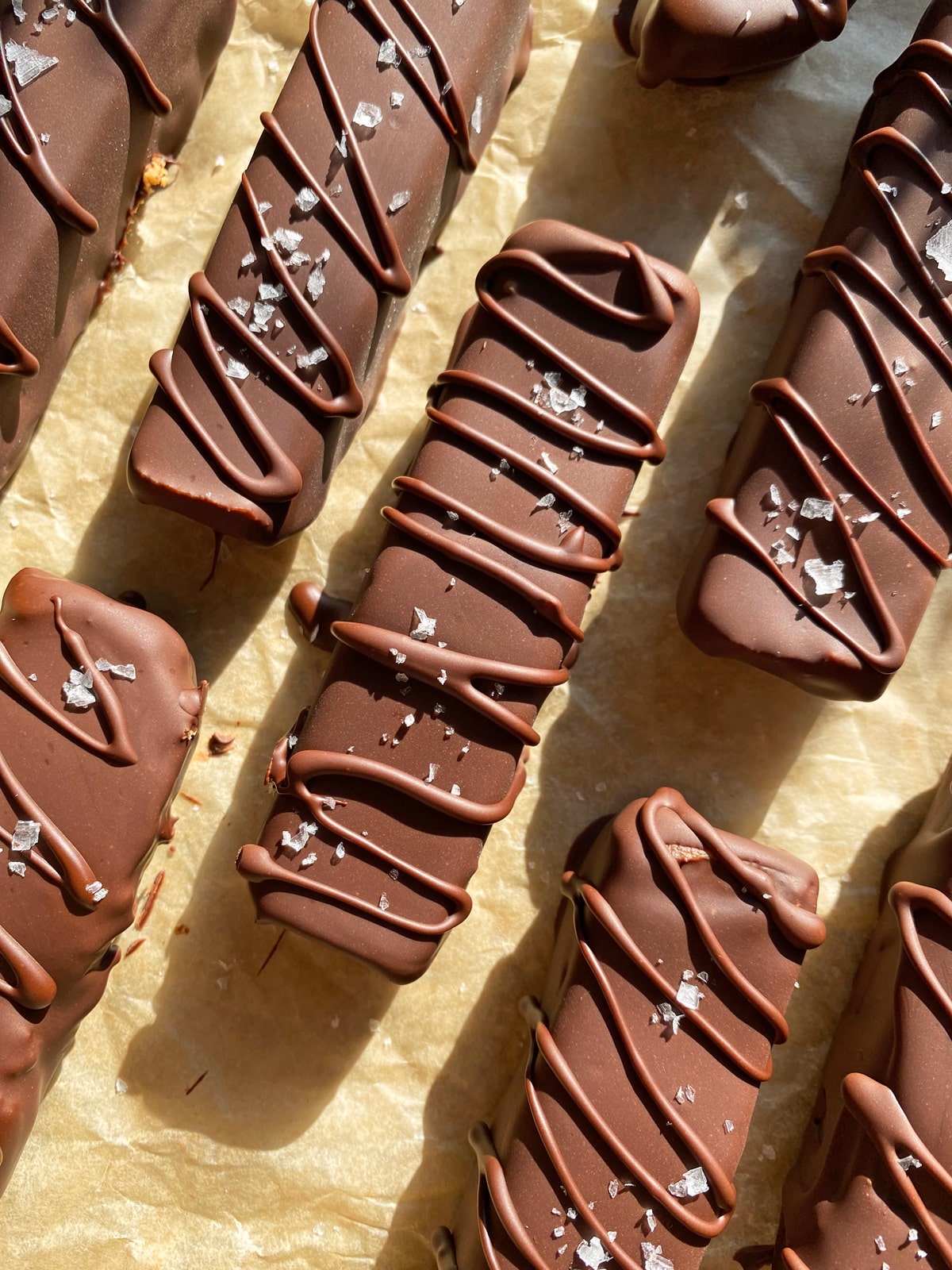 protein twix dipped and drizzled with dark chocolate, topped with flaked sea salt