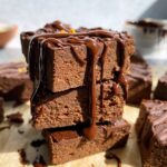 stack of three pumpkin brownies drizzled with dark chocolate