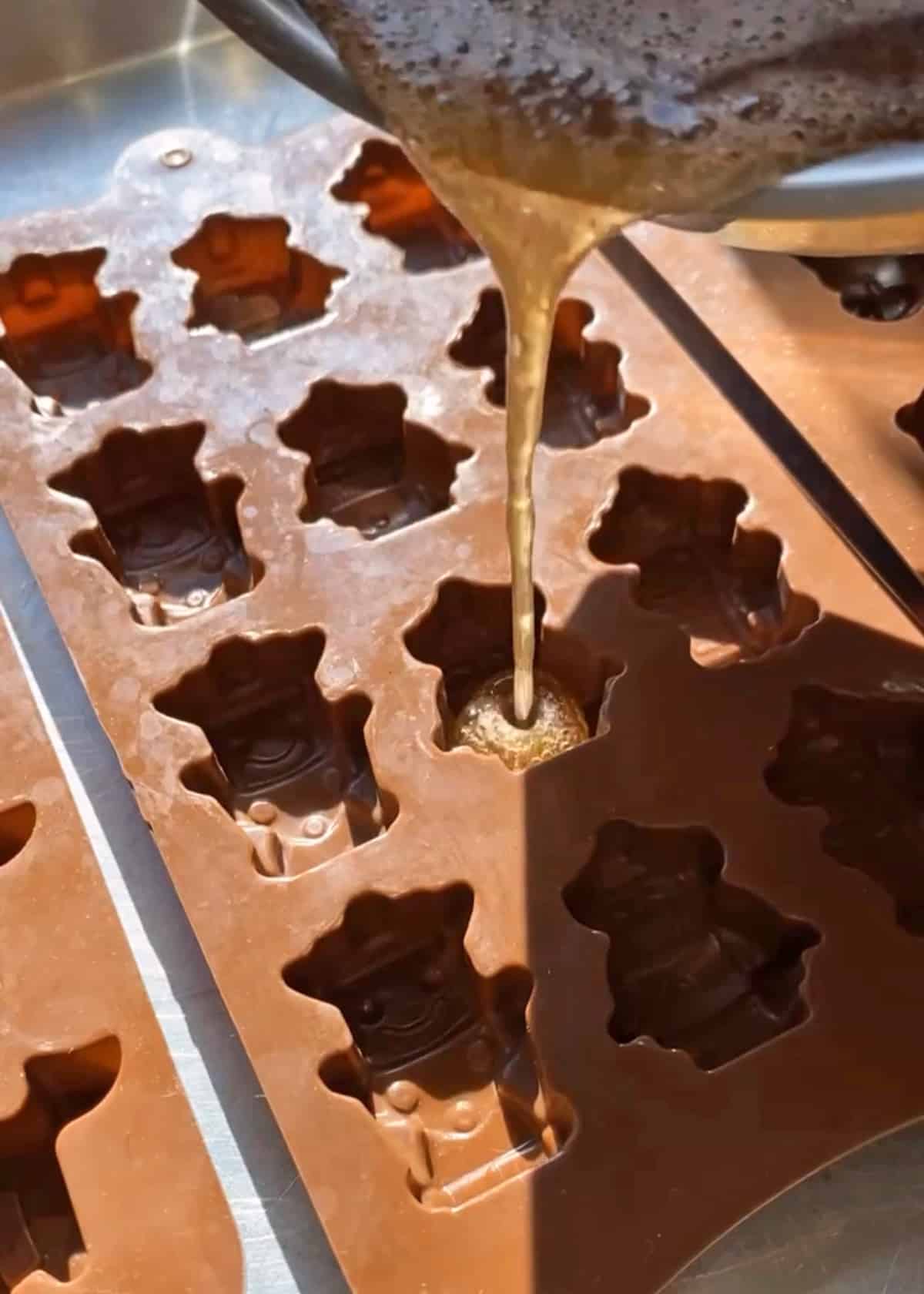 pouring the gummy mixture into the silicone mold