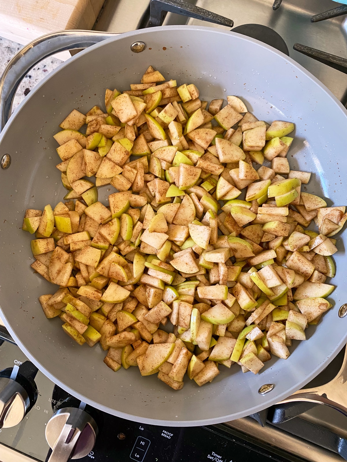 Cooking the apple filling in a frying pan.