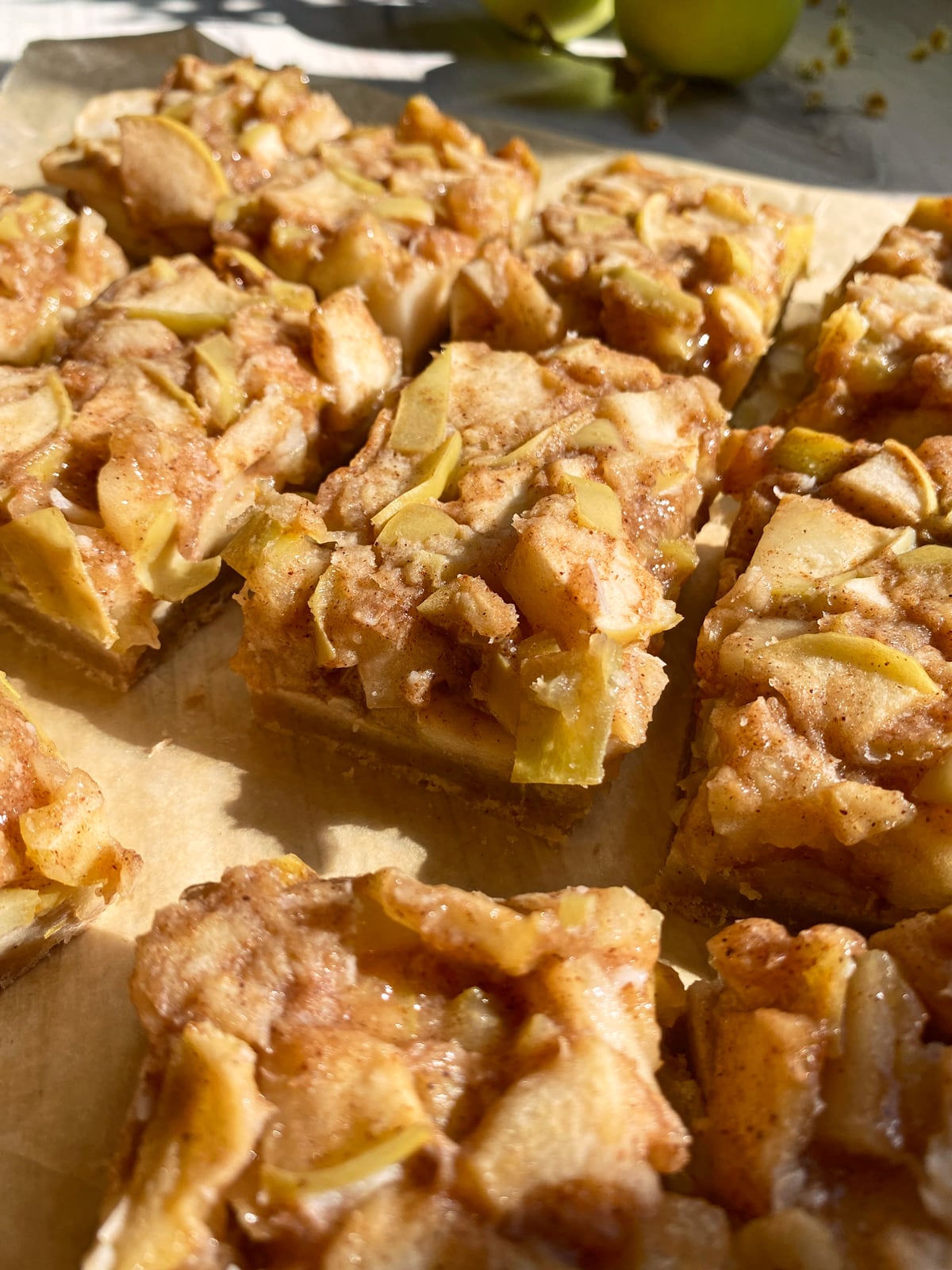 Baked and cooled apple pie bars that have been cut.