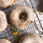 Top view of frosted butternut squash donuts.