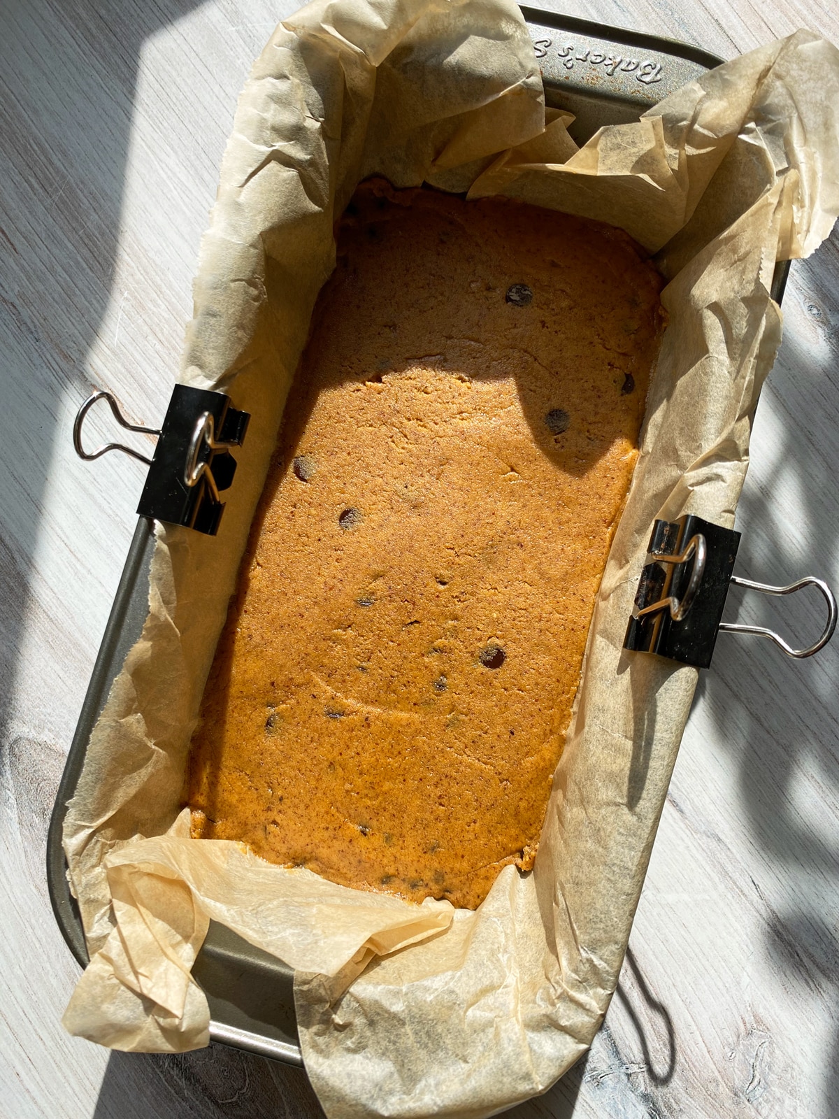 Protein pumpkin base in a lined loaf pan.