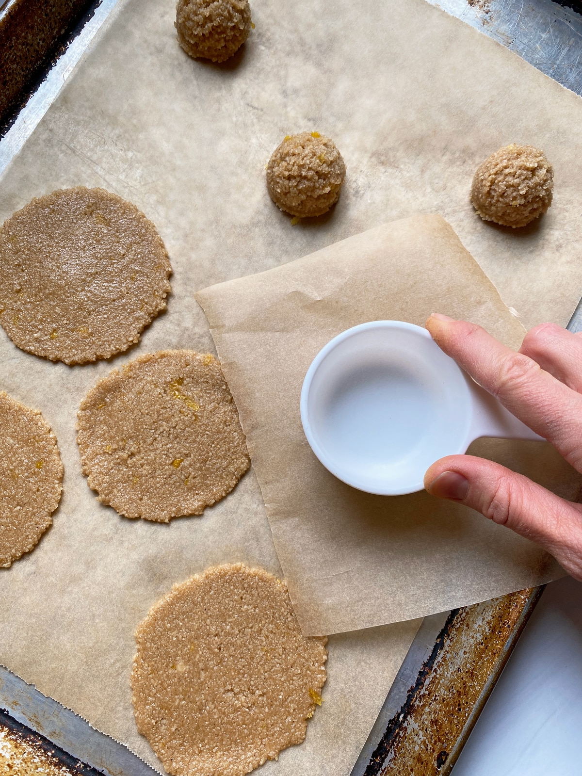 Flattening the cookie dough into discs.