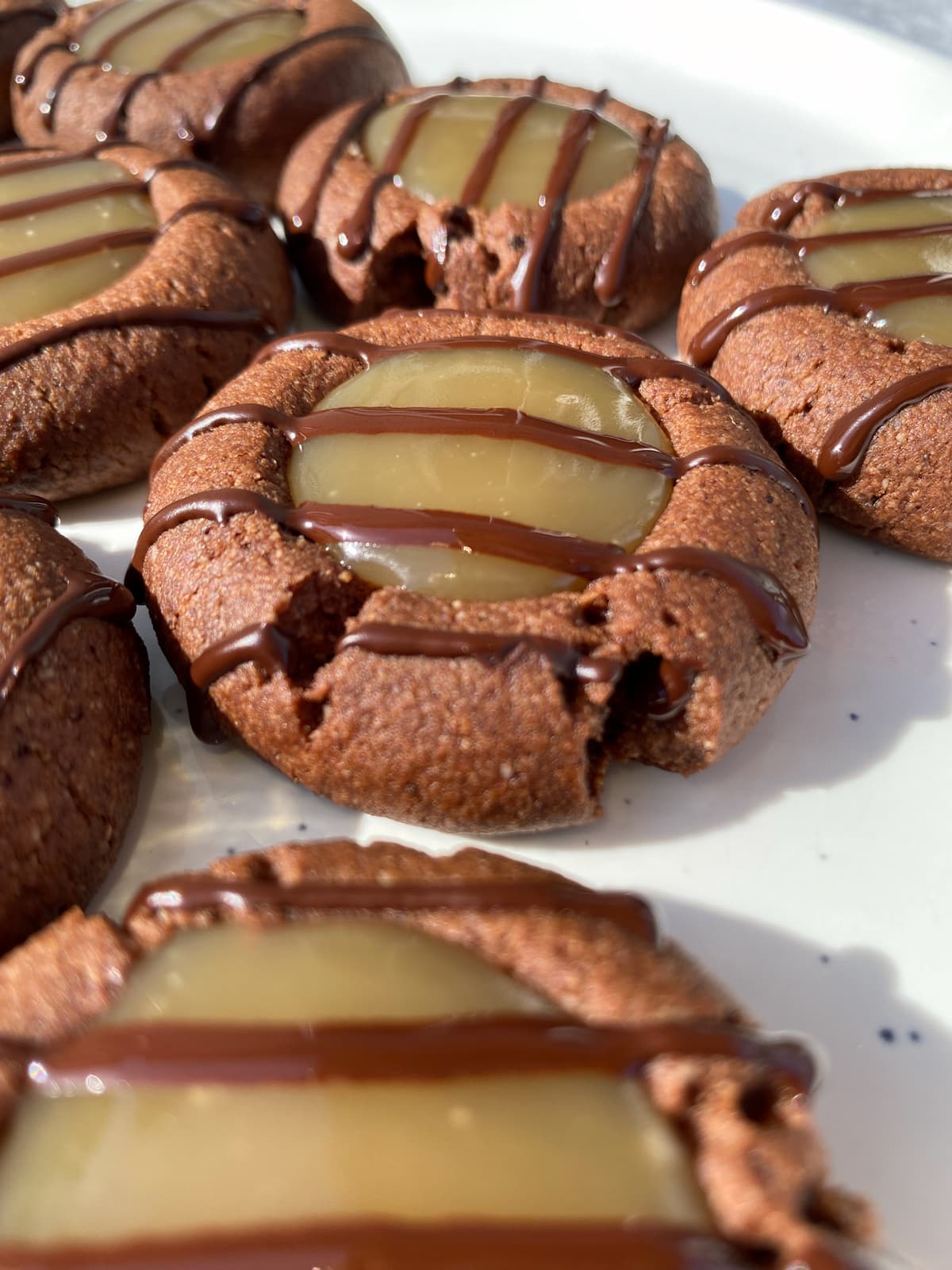 Side view of finished chocolate caramel thumbprint cookies.