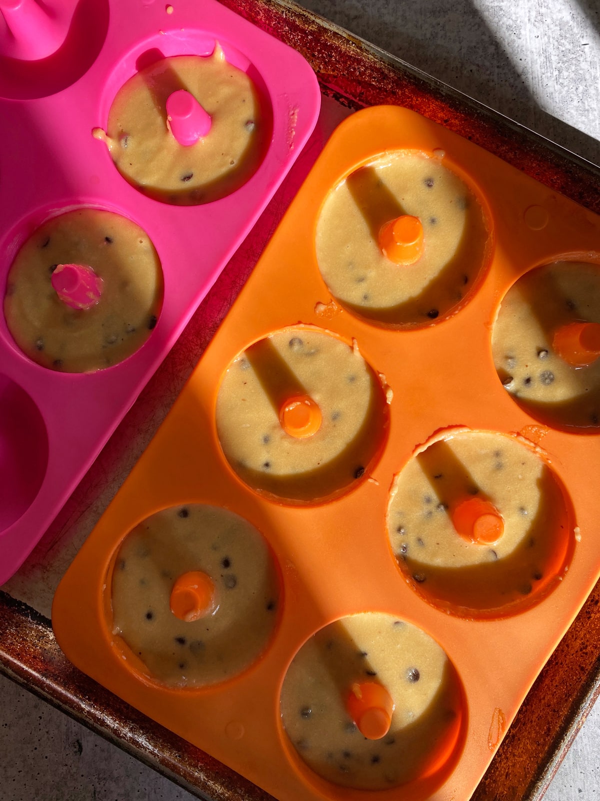 Chocolate chip donut batter in silicone donut pan.