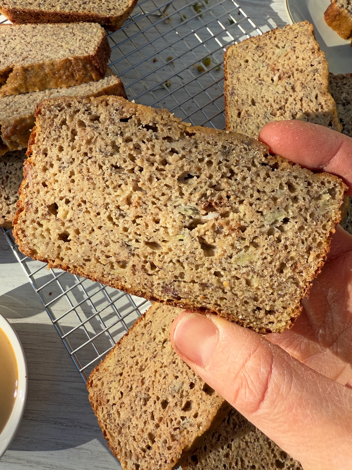 Holding a slice of bread.