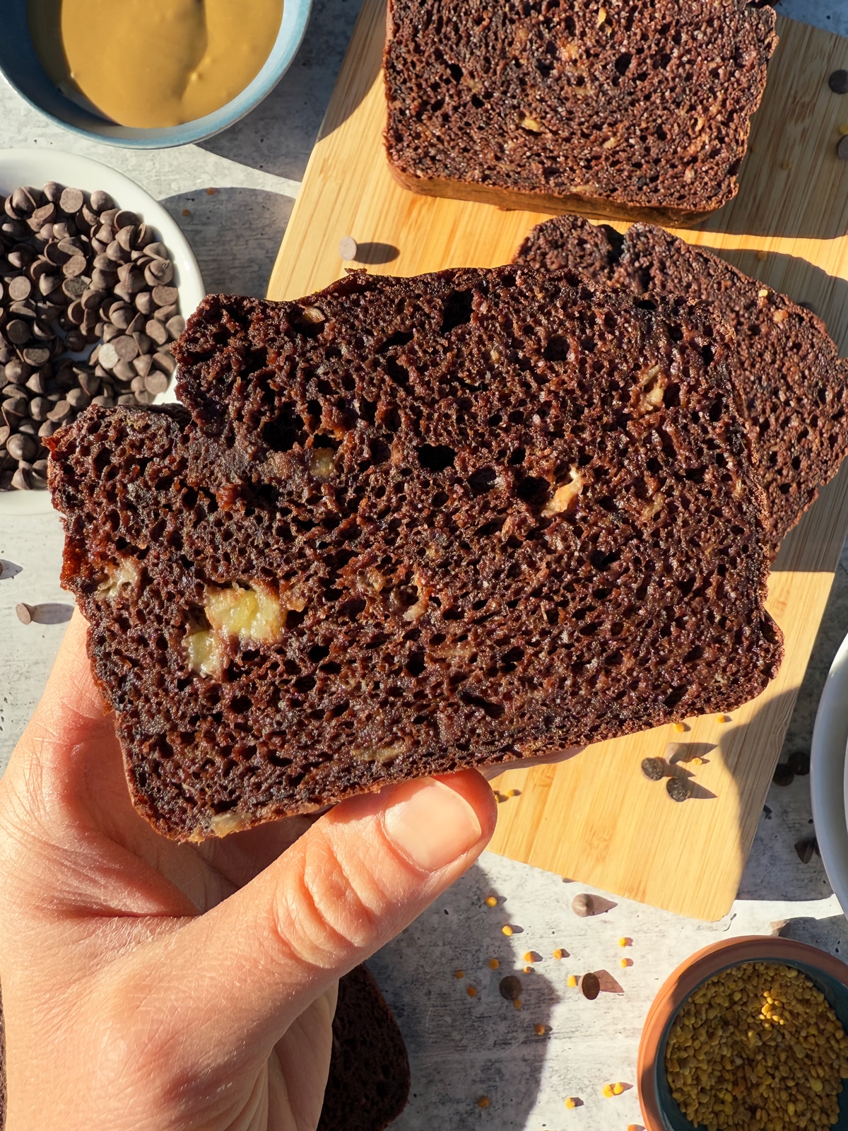 Holding a piece of bread.