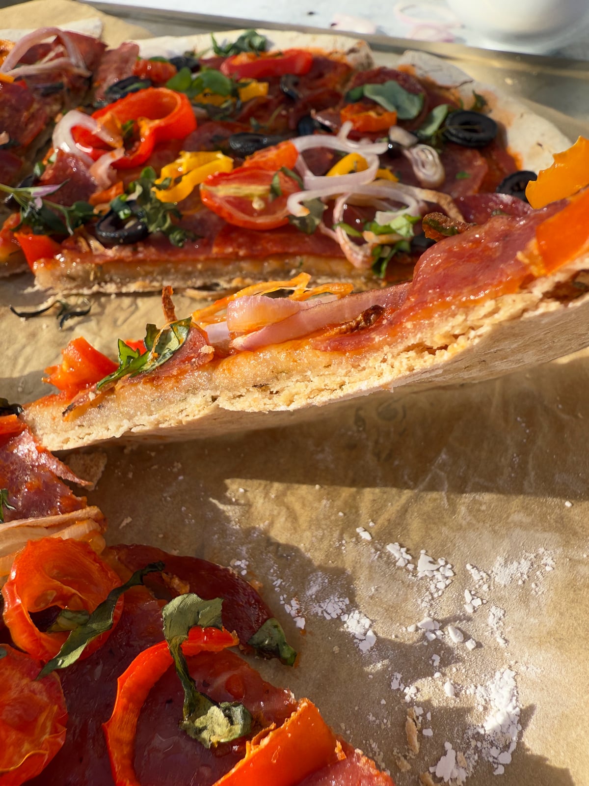Showing the side of a slice of pizza.