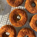 Freshly baked protein donuts coated in cinnamon sugar.