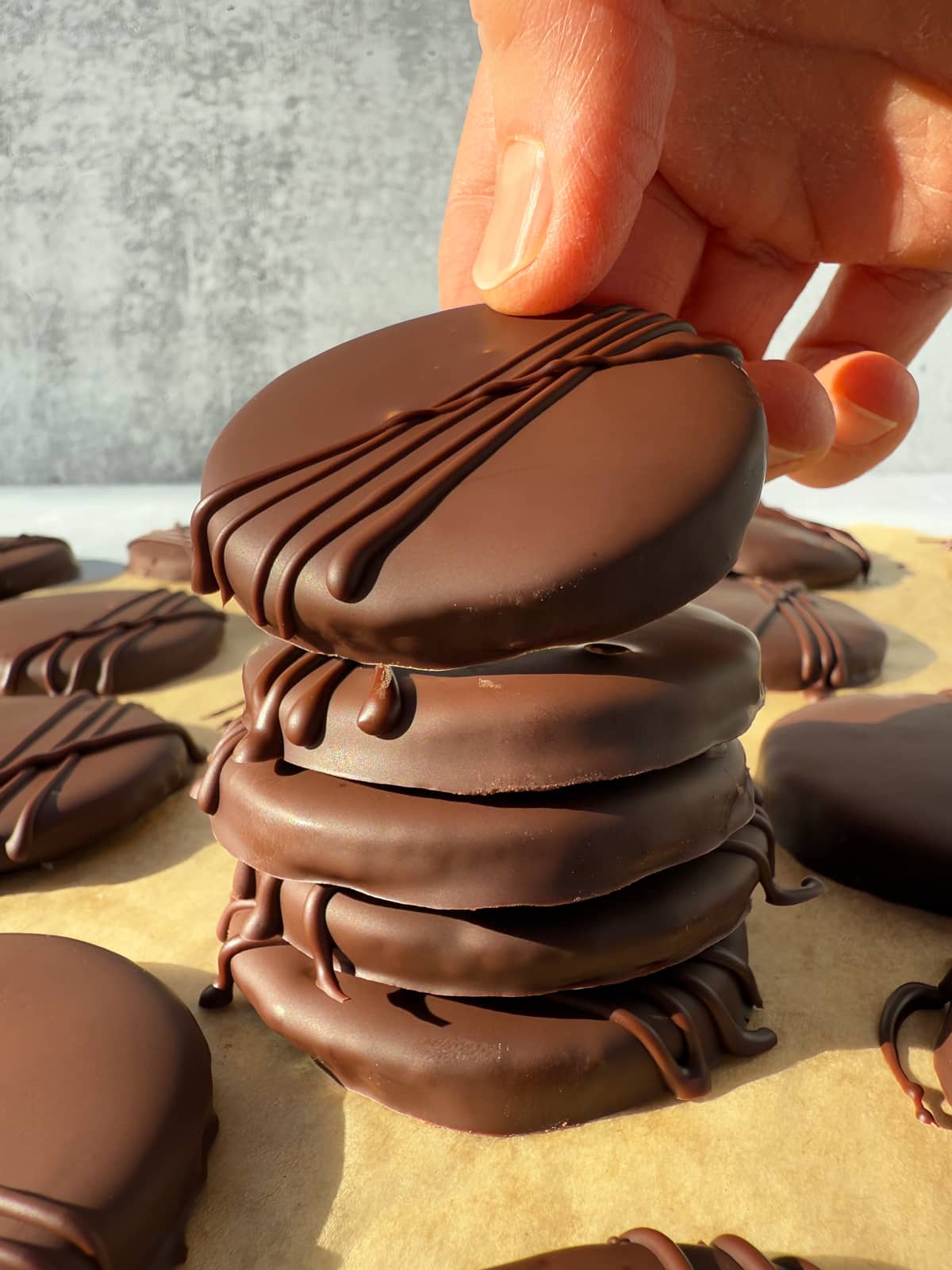 Grabbing a cookie from a stack of 5 cookies.