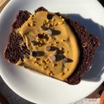 Slice of bread topped with sunbutter, chocolate chips and bee pollen.
