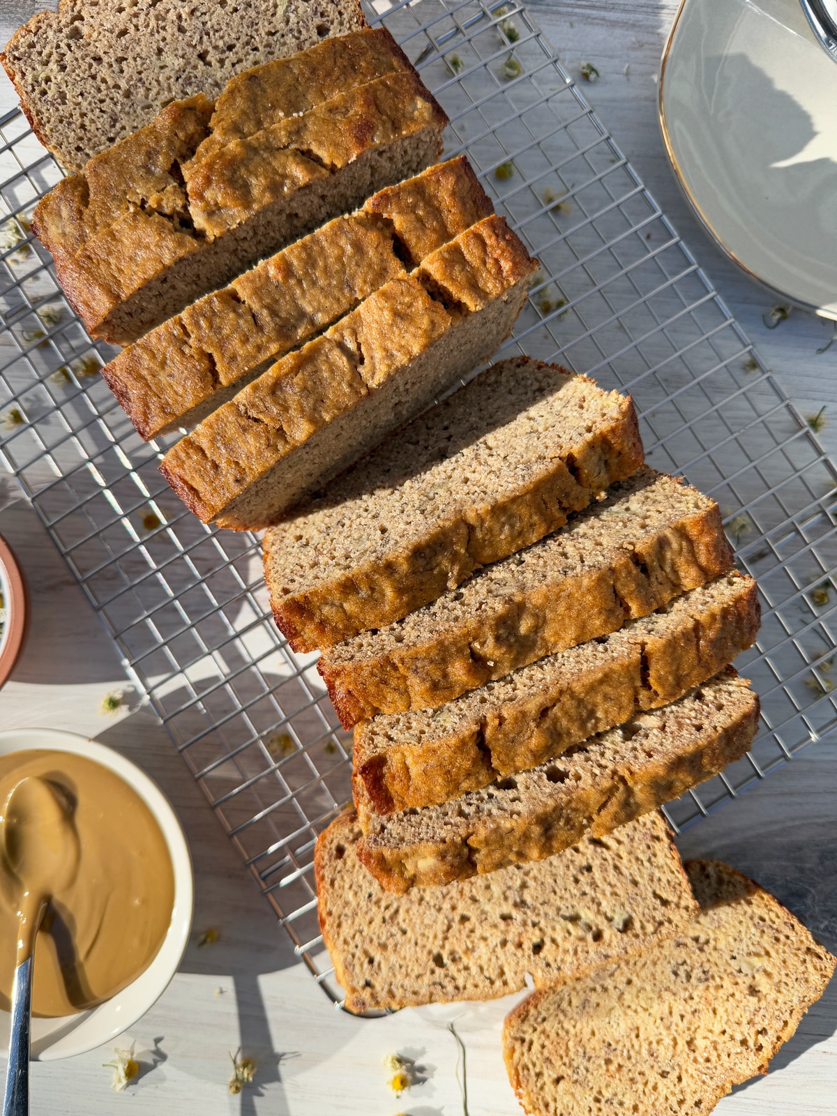Cut paleo coconut flour banana bread on wire cooling rack.