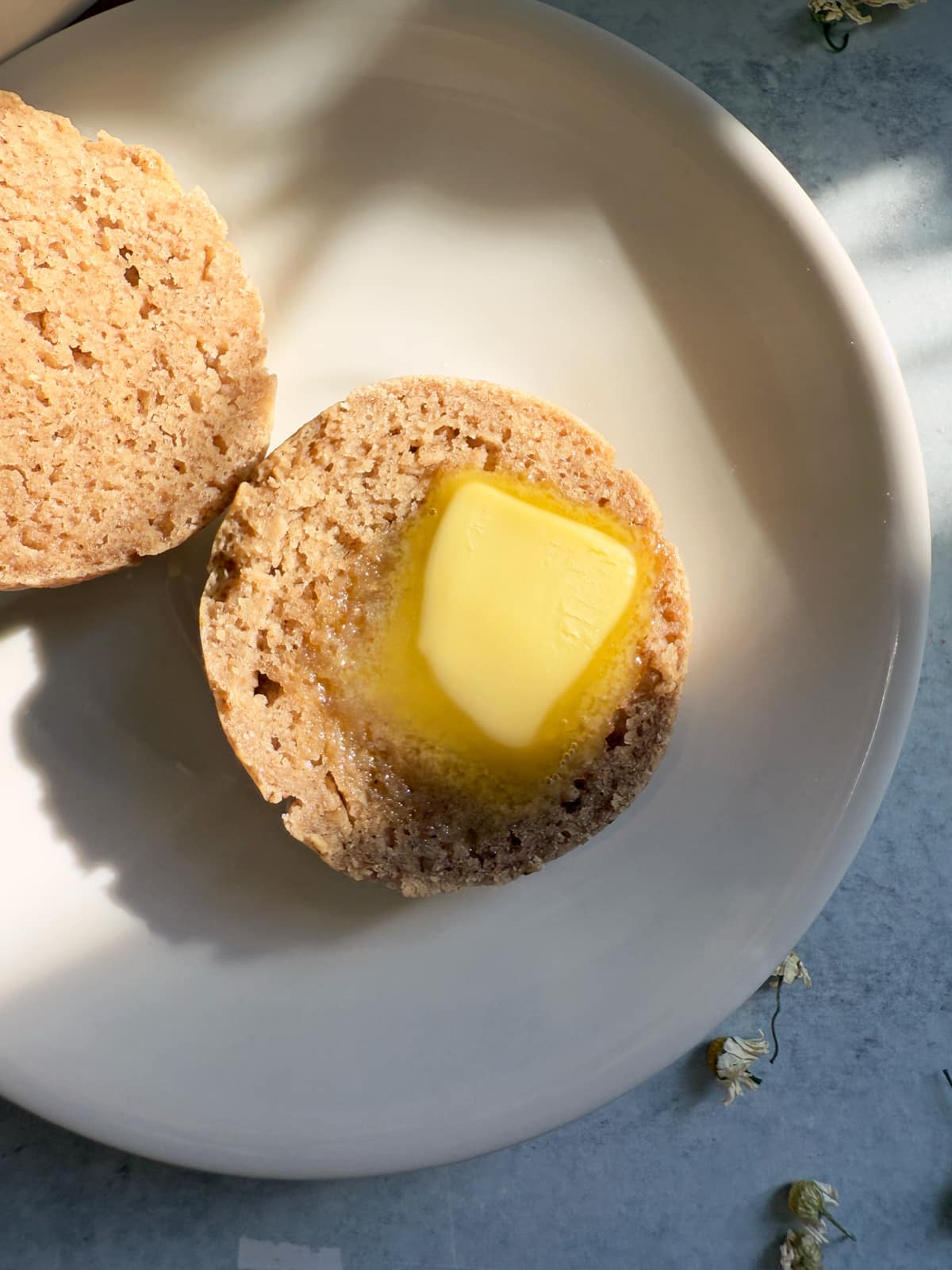 Sliced roll topped with butter.