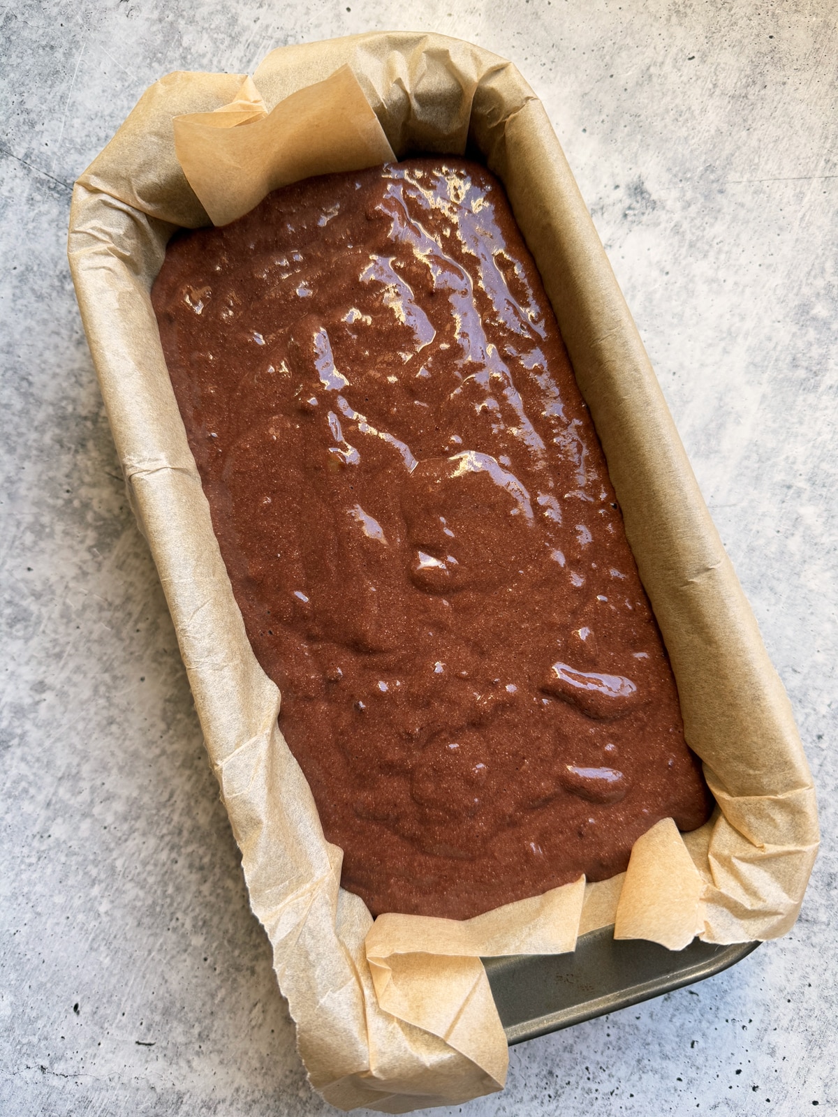 Batter in lined loaf pan, ready to bake.