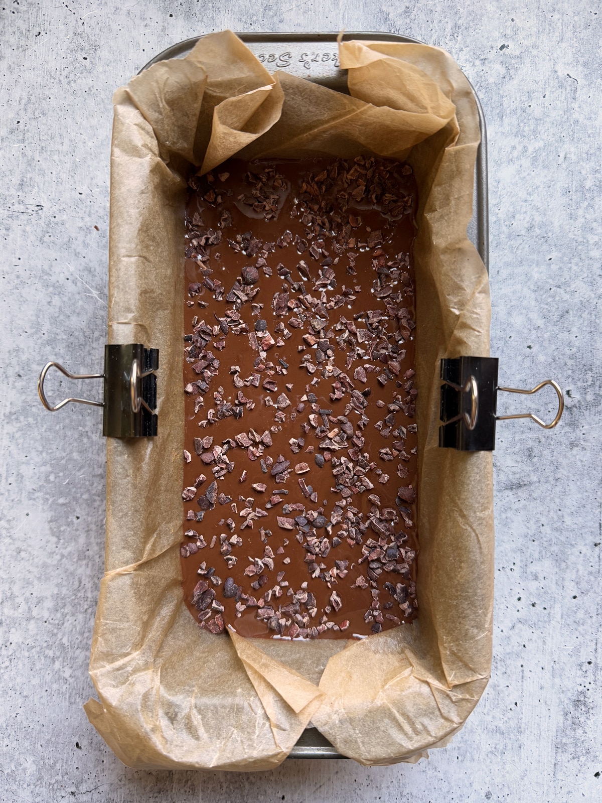 Assembled bars: base, chocolate fudge layer and cacao nibs.